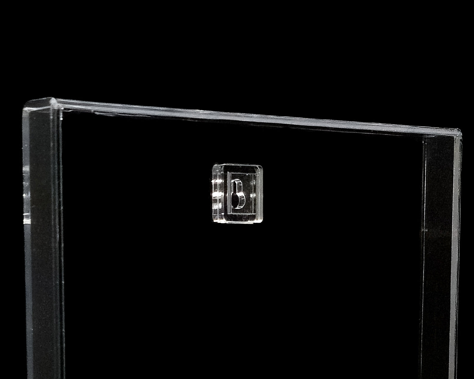 Clear plastic display case with a small logo on a black background