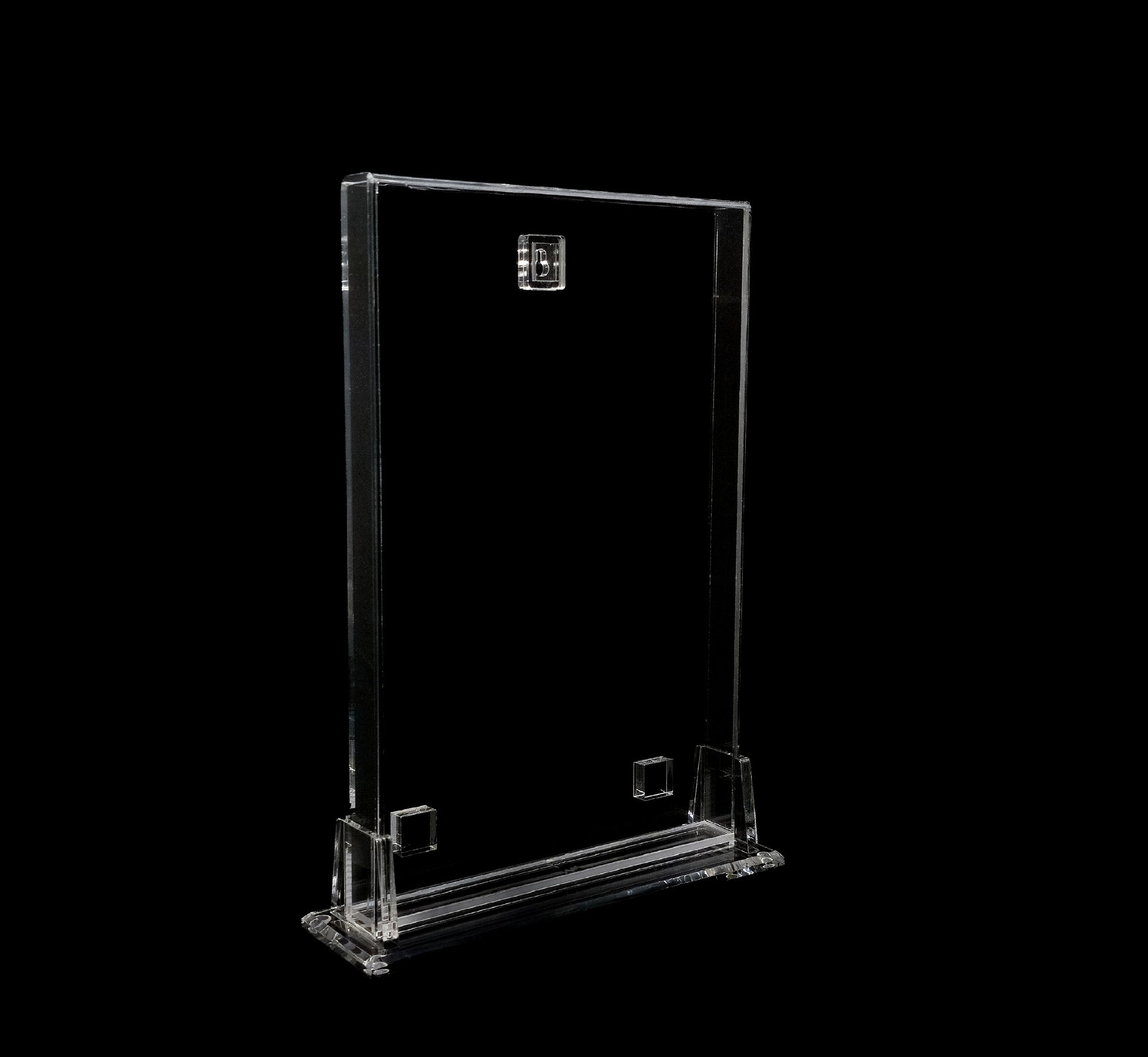Clear acrylic display stand on a black background