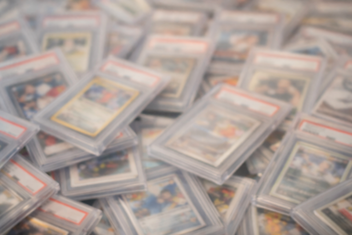 Stack of trading cards in protective sleeves on a blurred background